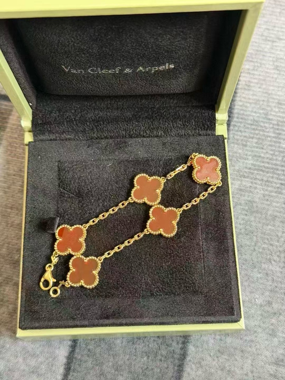 Van Cleef & Arpels Gold Bracelet with Coral-Red Alhambra Motifs